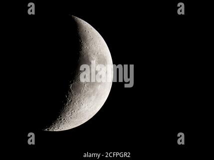 View of crescent Moon with telescope. Stock Photo