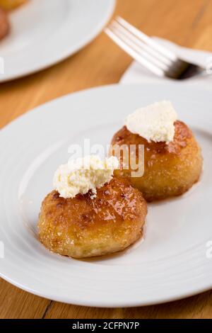 Turkish Dessert Kemalpasa / Sekerpare with milk cream Stock Photo