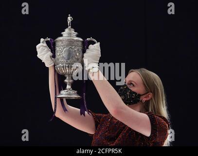 Laurel Kemp of Bonhams holding the oldest surviving FA Cup trophy during a preview of the sporting Trophies Sale at which will take place as Bonhams New Bond Street saleroom on September 29. The silver two-handled cup, estimated at GBP 700,000 -900,000, was made by Vaughton and Sons of Birmingham in 1896, and was presented to the FA Cup winning teams between 1896 and 1910, including Manchester United, Manchester City, Everton, Newcastle United and Tottenham Hotspur. Stock Photo