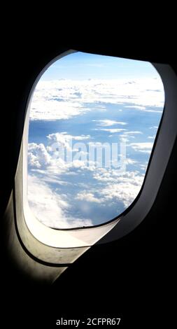 Looking out of Airplane Window - cloud view | Close up Stock Photo