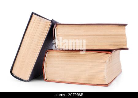 Three closed old thick paper books with yellow pages white background isolated closeup, book heap, pile, stack, vintage hardcover textbooks, education Stock Photo