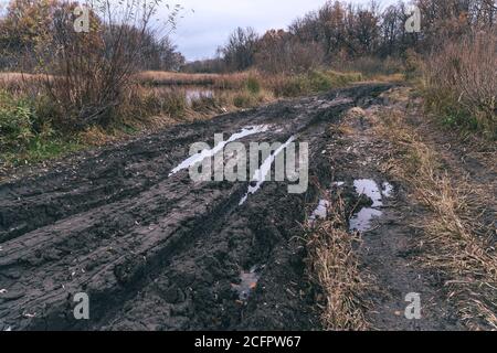 Deep ruts in the slushy autumn road Stock Photo