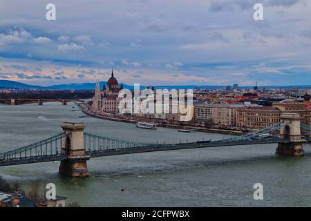 Aerial View at Chain Bridge leading over Danube river and Hungarian Parliament Building in the distance. Beautiful sky with view of Budapest city. Stock Photo