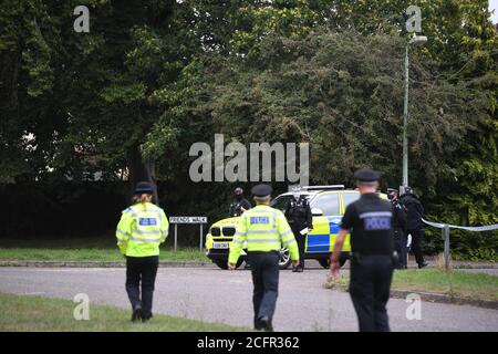 Suffolk Police officers walk towards the cordon at Friends Walk, Kesgrave, Suffolk, where a 15-year-old student from Kesgrave High School was shot just after 8.40am this morning. Suffolk Police have arrested teenage boy in connection with the incident. Stock Photo