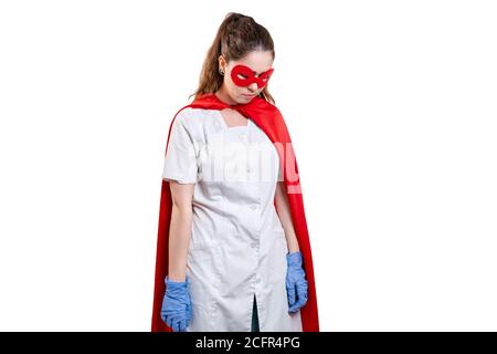 A tired doctor wearing face mask, gloves and a red superhero cape. Isolated on white background. The concept of the Power of a super hero for medicine Stock Photo