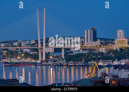 Vladivostok, Russia - Jun 11, 2020: Night view of the city of Vladivostok. Golden bridge in Vladivostok at night. Stock Photo