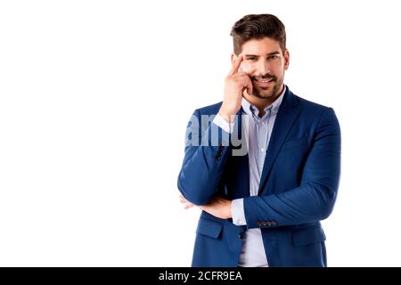 Close-up studio shot of thinking businessman standing at isolated white background. Copy space. Stock Photo