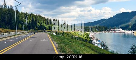 Landscape view of bike path and way only for pedestrian. Cycle track road sign along mountain forest lake resort Stock Photo