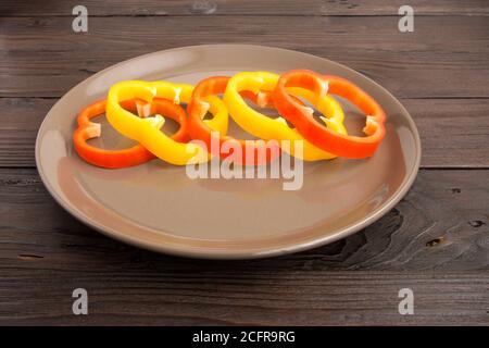 Scrambled eggs fried in rings of Bulgarian pepper with tomatoes and herbs. Stock Photo