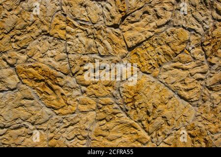 The background is made of wild stone. A beautiful wall of stone. Stock Photo