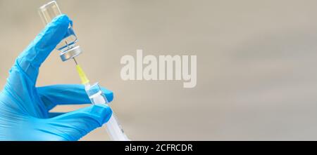 Biology and science. Scientist holding a syringe and vaccine vial. Global alert. Vaccination. Covid-19. Coronavirus. Research. Stock Photo