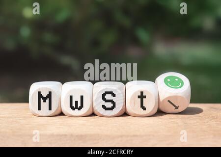 Duty and taxes. German tax cut on value-added tax (VAT). Wooden blocks with one inverted block. VAT reduction with green happy smiley. Economic crises Stock Photo