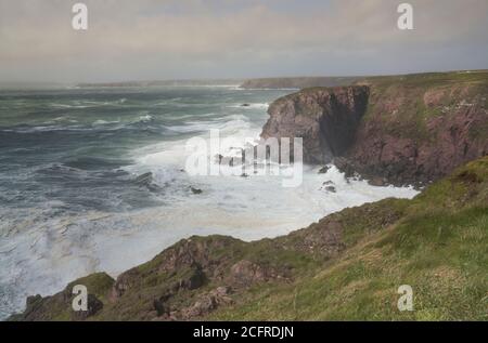 Storm pounding the cliffs near St. Ann's Head, entrance to Milford Haven, Pembrokeshire, Wales Stock Photo