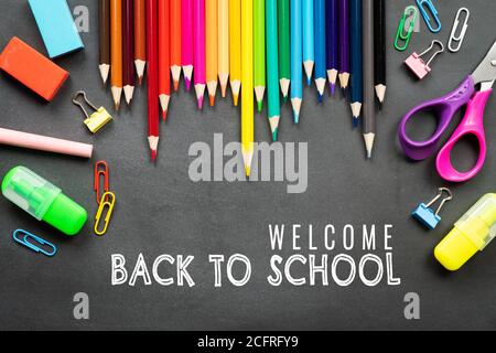 School supplies on black board background. Back to school concept Stock Photo