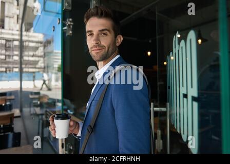 Young businessman buying a coffee for his morning commute Stock Photo