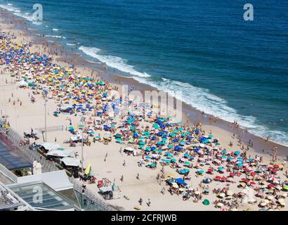 Leblon Beach, Rio De Janeiro, Brazil, 2019.  Locals and Holidaymakers enjoying a relaxing day on the beach.  It is one of the city’s trendiest, most t Stock Photo