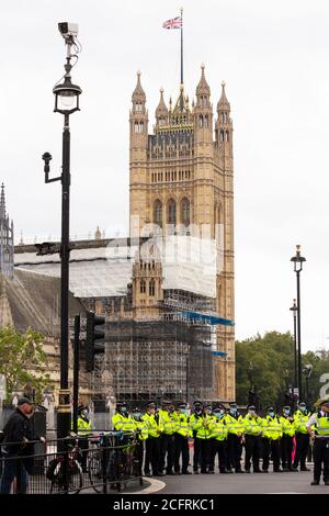 Police blockade in front of Houses of Parliament, 'Carnival of Corruption' Extinction Rebellion demonstration, London, 3 September 2020 Stock Photo
