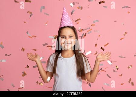 Childhood, mood and emotions. Smiling little girl enjoy confetti on birthday Stock Photo