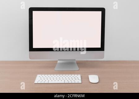 close up of computer with keyboard and mouse on a wooden table Stock Photo