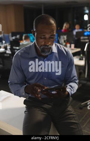 Senior businessman using digital tablet at modern office Stock Photo