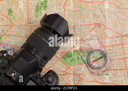 professional photo camera on a map with a compass, travel photographer, details, studio Stock Photo