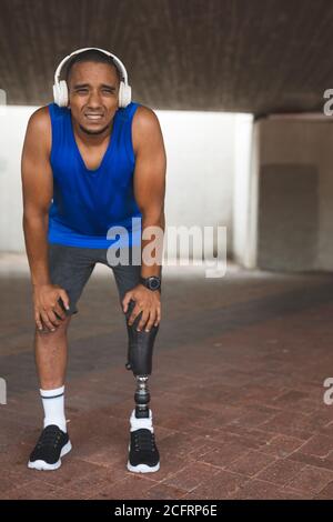 Man with prosthetic leg taking a break from running Stock Photo
