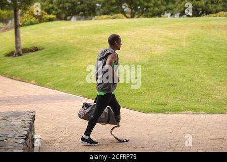 Man with prosthetic leg walking in the park Stock Photo