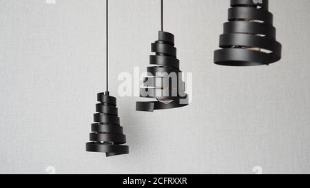 A modern loft chandeliers made of black metal spiral in a stylish white interior Stock Photo