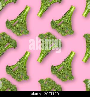 Seamless pattern with fresh broccoli with water drops isolated on pink background Stock Photo