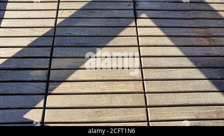 Wooden background. The brown boards are laid out in a specific order. Natural natural material. Environmental friendliness. Stock Photo