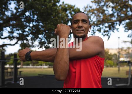 Man performing stretching exercising in the park Stock Photo