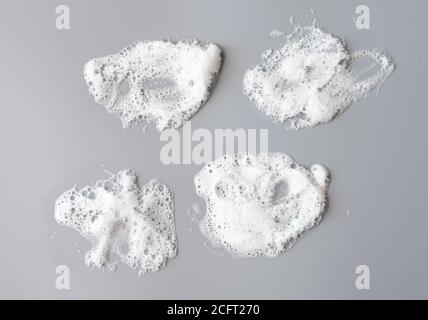 White foam on gray surface as texture Stock Photo