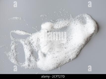 White foam on gray surface as texture Stock Photo