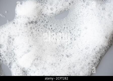 White foam on gray surface as texture Stock Photo