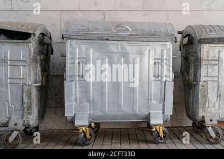 Metal trash can on wheels. Garbage collection in the city. Stock Photo