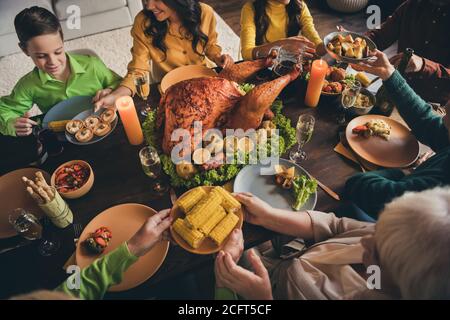 Cropped photo of full family relative gathering sit served dinner table share mom granny fetch food plate corn potato snacks lovely atmosphere multi Stock Photo
