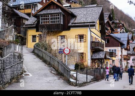 Hallstatt, Austria - March 4, 2017: View of Tourists Sightseeing and Traditional Houses in Hallstatt, Upper Austria Stock Photo