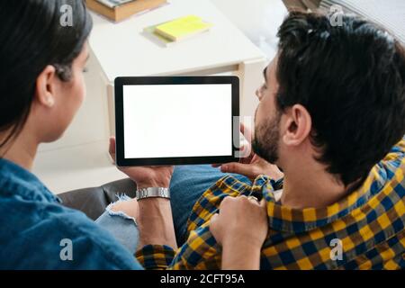 Young Couple Holding Tablet With Blank Screen For Copy Space Stock Photo