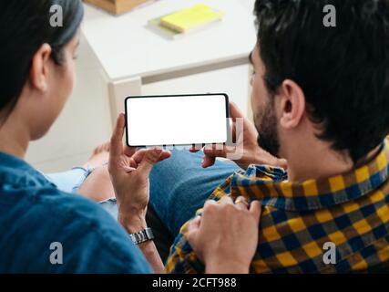 Young Couple Holding Phone With Blank Screen For Copy Space Stock Photo