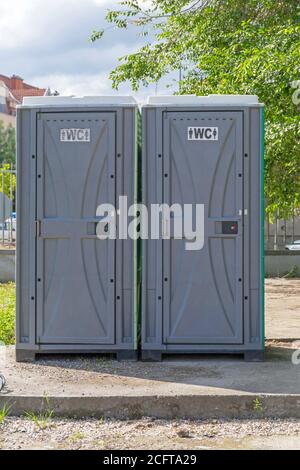 Two Plastic Cabins Chemical Toilets at Festival Stock Photo