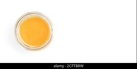 Glass jar with amber coloured honey, view from above, isolated on white background, space for text right side Stock Photo