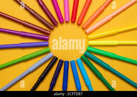 Colored markers on orange background Stock Photo