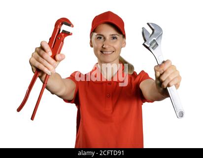 handyman services - smiling handywoman in red uniform with repair tools in hands isolated on white background Stock Photo