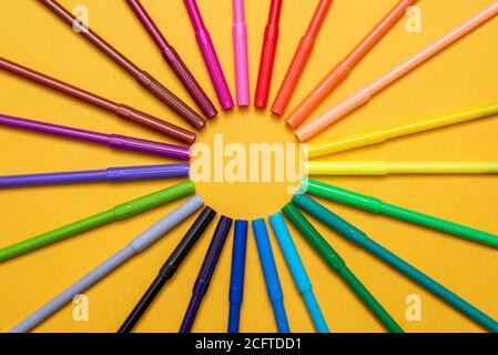 Colored markers on orange background Stock Photo