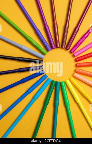Colored markers on orange background Stock Photo