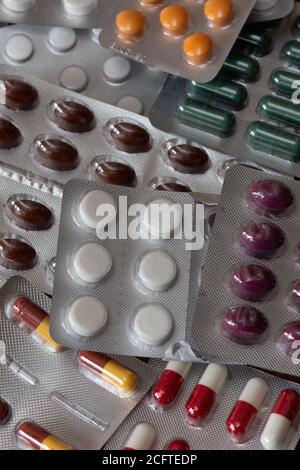 Different kinds of medicine tablets and pills in blister packs. Concepts of pharmaceutical industry and drugs consumption Stock Photo