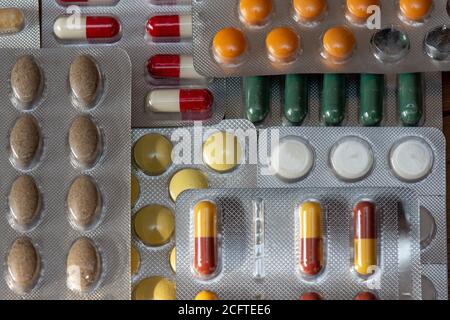 Different kinds of medicine tablets and pills in blister packs. Concepts of pharmaceutical industry and drugs consumption Stock Photo