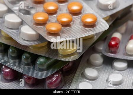 Different kinds of medicine tablets and pills in blister packs. Concepts of pharmaceutical industry and drugs consumption Stock Photo