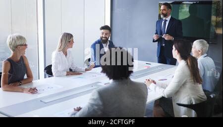 Portrait of happy business people discussing together in office Stock Photo