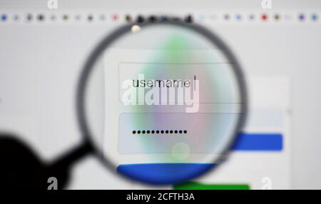 View through a magnifying glass on login page screen with username and password box in internet browser. Stock Photo
